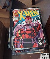 Stack of comics, top issue X-Men with Magneto cover