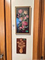 Needlepoint and marquetry plaque hanging together on wall