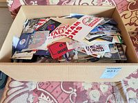 Box filled with assorted paper sports memorabilia