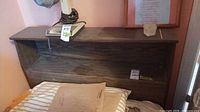 Front view of twin headboard on bed showing shelf and laminate finish