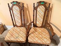 front view of two chairs showing upholstery pattern and wood frames