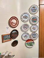Full wall view showing entire assortment of plates and framed pieces