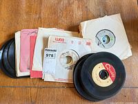 Stack of approximately twelve 7" singles with various company sleeves