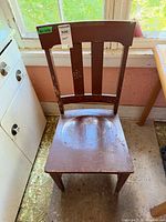 front view of brown slat-back wood chair