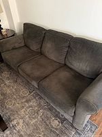 full view of dark sage green three-seat sofa