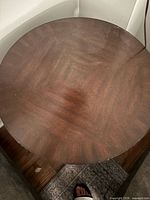 Top view of dark wood round table showing grain and finish
