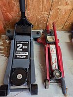 Pittsburgh grey low profile jack beside red trolley jack