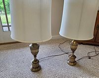Both brass lamps with shades and cords visible