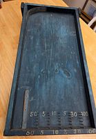 Full view of blue wooden carnival game board showing layout and scoring numbers