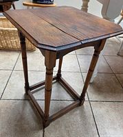 Full view of oak side table showing overall design and stretcher base