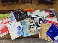 Wide shot of all sheet music and songbooks spread on table