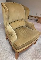 Front angled view of corduroy wingback armchair