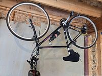 Full view of black Specialized Cross Roads bicycle hanging upside down