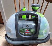 Front view of Bissell Little Green cleaner showing tanks, hose, brush head