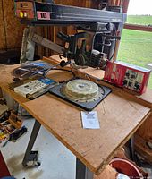 Full view of radial arm saw on stand with accessories