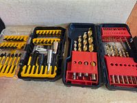 Three open bit sets showing contents and cases