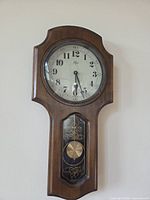 Full front view of Elgin wooden wall clock showing overall design and condition