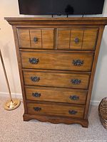 Front view showing five drawers, hardware, finish, base