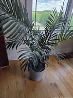 Full view of faux palm tree in bucket planter