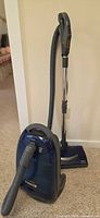 Full view of Kenmore Progressive canister vacuum with hose, wand and Power-Mate head