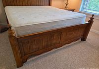 King mattress on box spring shown on bed frame