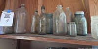 Full shelf view displaying all antique jars and bottles