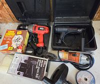 Overview of drill, heat gun in cases, grinder, glue gun kit box, paint stripper wheel