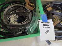Green bin with multiple coils of wire and small connectors