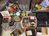 Overhead view showing screws, nails, fasteners, plastic totes, multi-drawer organizer and assorted boxes