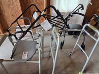 Group view of multiple walkers, rollator and commode frame
