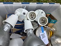 Close-up of spotlight heads and loose reflector bulbs in tote