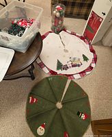 Two tree skirts, ornament cylinder and partial view of tote