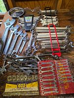 Overall view of lot showing adjustable, combination, open-end wrenches, rack, vinyl pouch and boxed sets