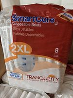Front of sealed retail bag showing Tranquility SmartCore 2XL disposable briefs, pack of 8