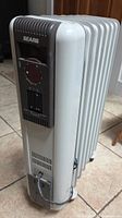 Angled full view of Sears oil-filled heater showing fins, control panel, power cord