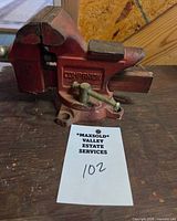 Front view showing Companion logo on side of red bench vise