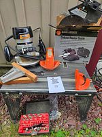 Full lot showing router, table, guide box, accessories and bit set