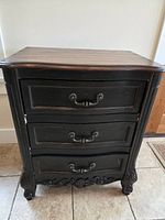 Full view of chest showcasing drawers and carving