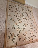 Full view of floral area rug on carpeted floor