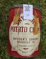 Full view of tin with label and handle visible