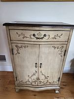 Full front view of painted wooden cabinet with drawer and doors