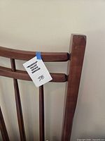 Close view of wooden slat headboard with lot tag