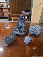 Front view of all four soapstone figurines displayed together