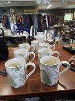 Front angled view of seven Corelle mugs showing pattern and quantity