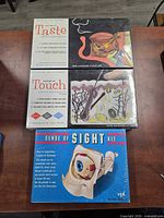 Front view of all three boxed kits showing titles and artwork