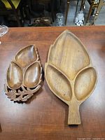 Front view of both leaf trays showing compartments and size difference