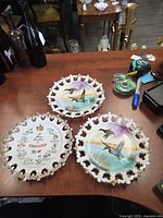 Three porcelain plates on table showing overall designs