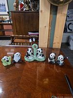 All six ceramic panda pieces displayed on tabletop