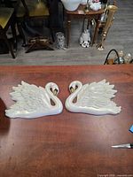 Front view of both swan plaques showing design, color, size