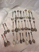 Full layout of roughly 28 souvenir spoons
